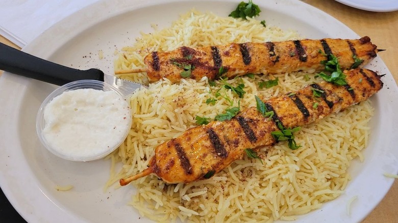 Grilled chicken breast with housemade BBQ sauce on a white plate