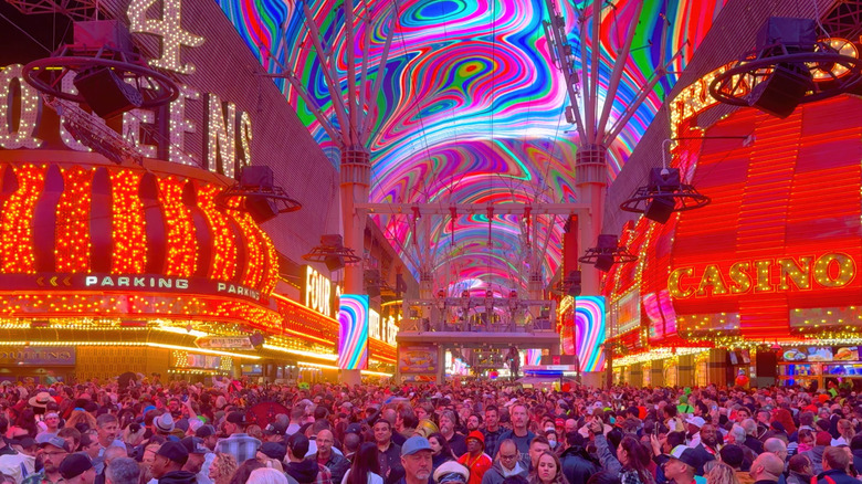 Crowds walking on Fremont Street at night under the LED canopy.
