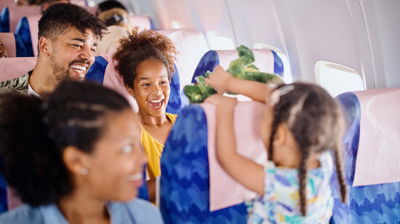 Smiling family in plane cabin