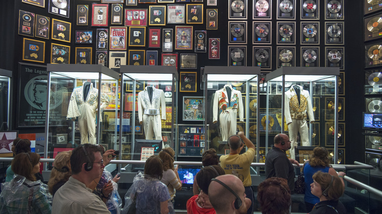 Graceland Elvis costumes records with crowd of people
