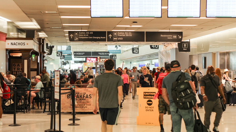 Passengers walking through the terminal near restaurants at William P. Hobby Airport in Houston.
