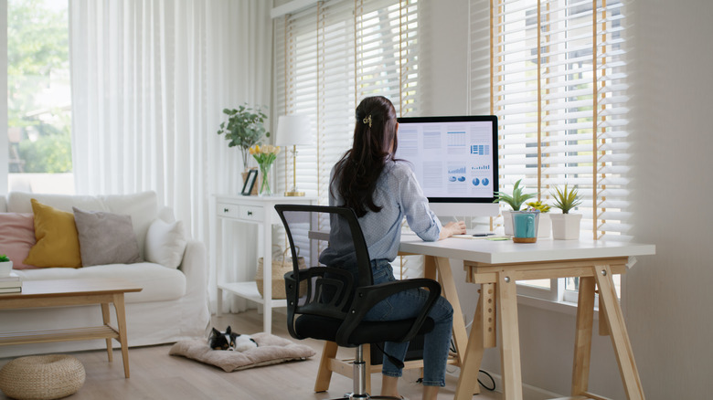 A woman working on a computer at a desk