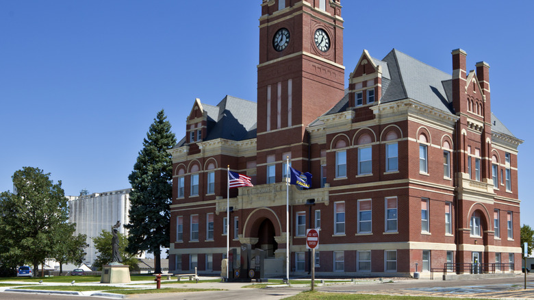 Romanesque building with red bricks and a clock tower