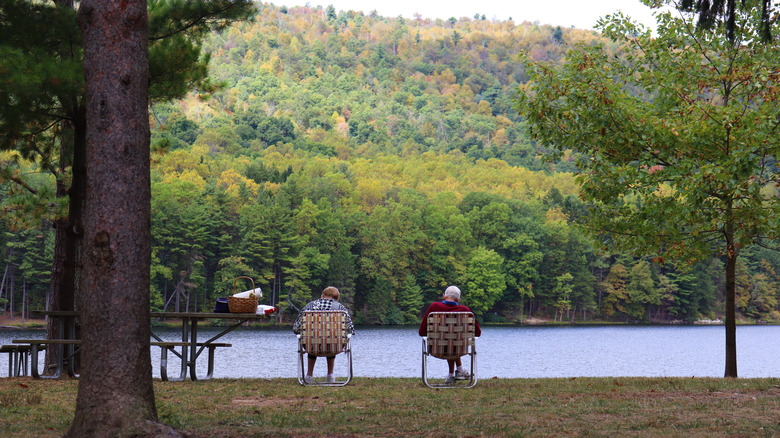 A couple sit at a lakefront campsite at Cowans Gap State Park.