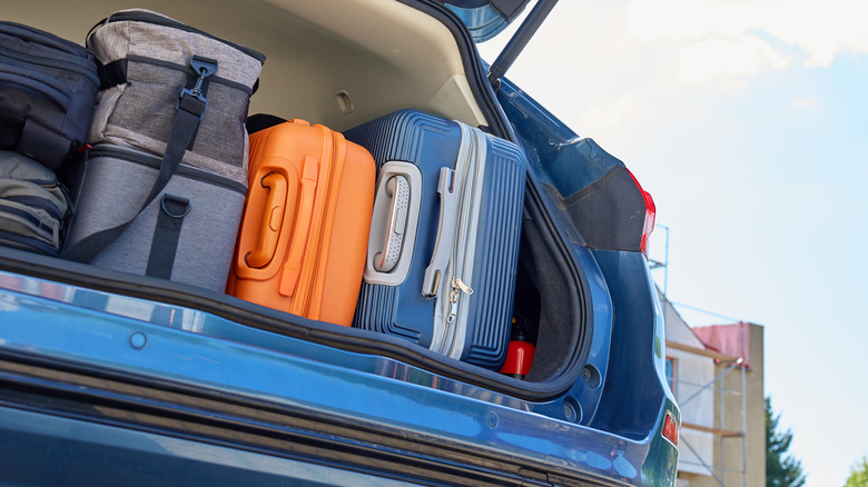 Car trunk fully packed with suitcases