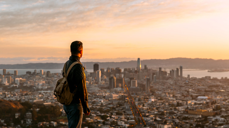 A hiker takes in the view of the San Francisco skyline from the Twin Peaks Trail