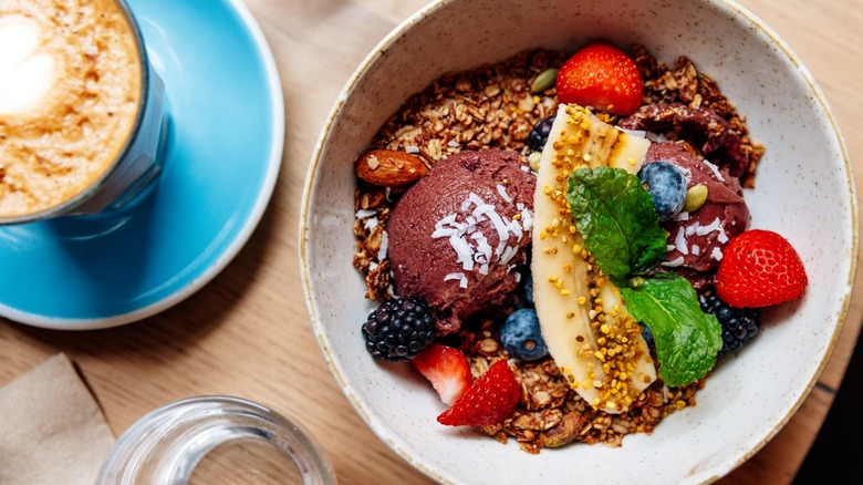 A healthy acai bowl and accompanying coffee drink