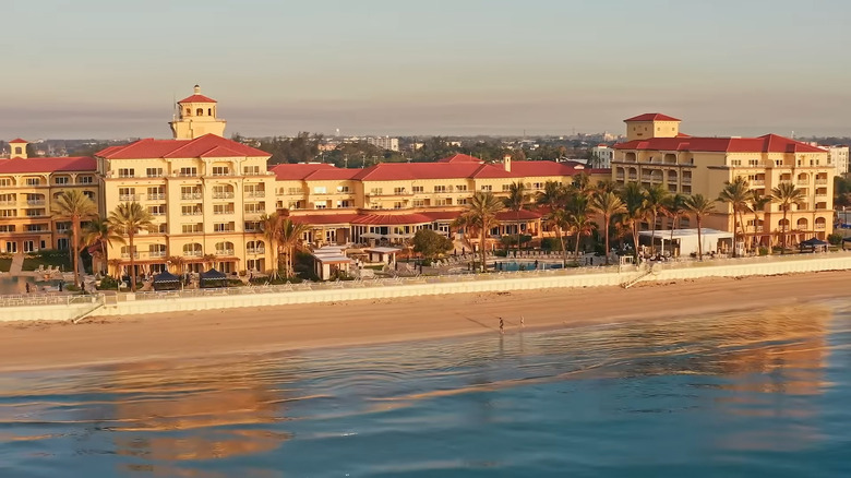View of Eau Palm Beach property from the water at sunset.