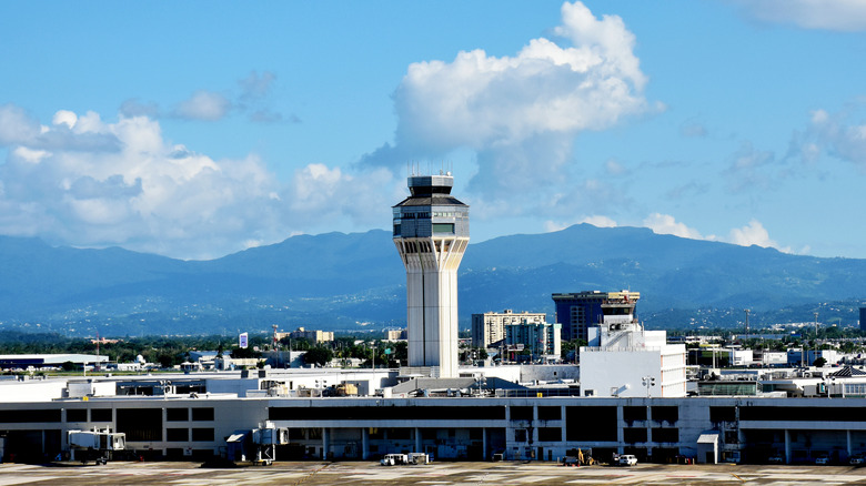 Puerto Rico's Luis Muñoz Marín International Airport seen from a distance with mountainous background