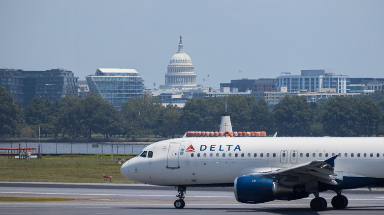 Delta flight on the tarmac at Ronald Reagan Washington National Airport (DCA) with the Capitol building in the background