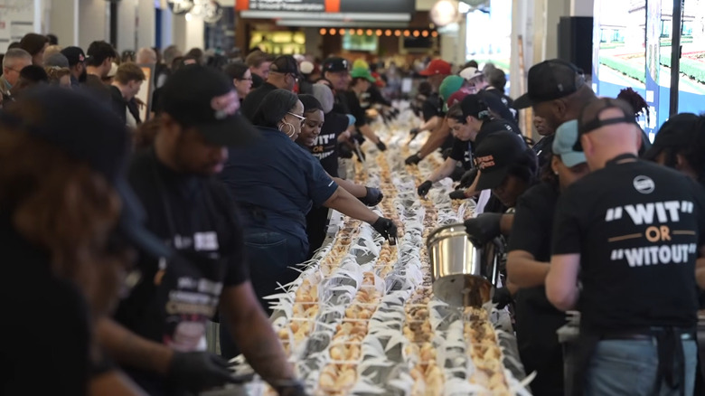 Workers setting up the longest line of cheesesteaks in the world for a Guinness World Record