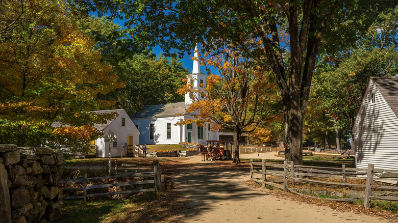 Two historic buildings in Old Sturbridge Village in the fall season.