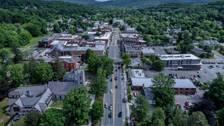 A beautiful New England town and street surrounded by green trees