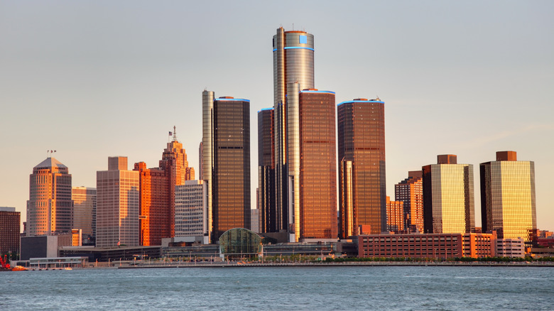 The Detroit, Michigan, skyline and Renaissance Center reflected in warm golden sunlight across the water at dusk
