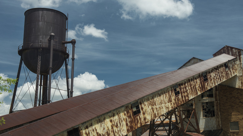 Rusted remnants of of an old building and water tower in Farmington, Missouri