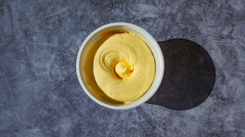 Aerial shot of a tub of margarine on a gray countertop