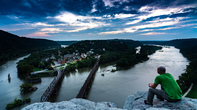 man looks down on Harpers Ferry