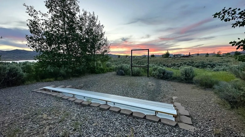 A sunset view at Nevada's Wild Horse Recreational Area features open meadows, a lake (at left), and rolling hills.