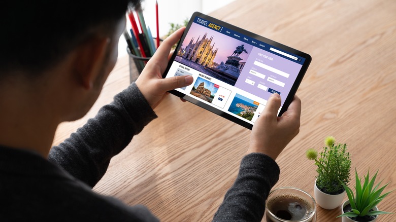 Person searches for flights on tablet
