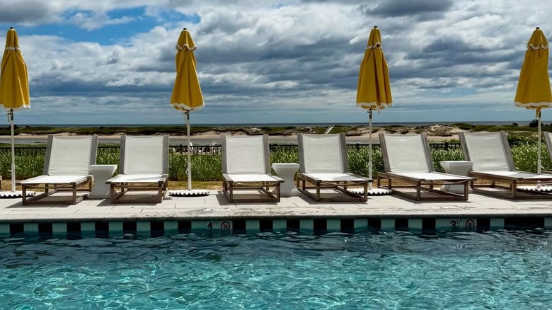 Poolside lounge chairs and yellow umbrellas at The Dunes on the Waterfront in Ogunquit, Maine