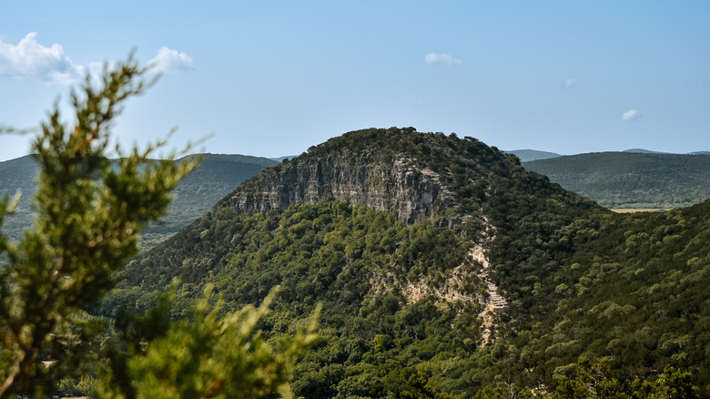 Old Baldy covered in rocks and shrubs near Bear Creek State Park.