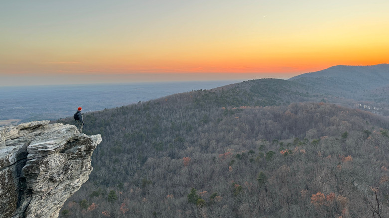 Hiker at Hanging Rock State Park watching sunset