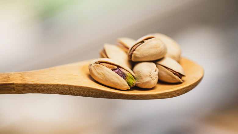 Shelled pistachio nuts on a spoon