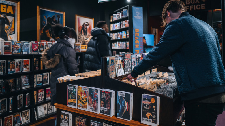 Visitors browse the basement shelves of Kim's Underground Video located in the basement of the Alamo Drafthouse in lower Manhattan, NYC