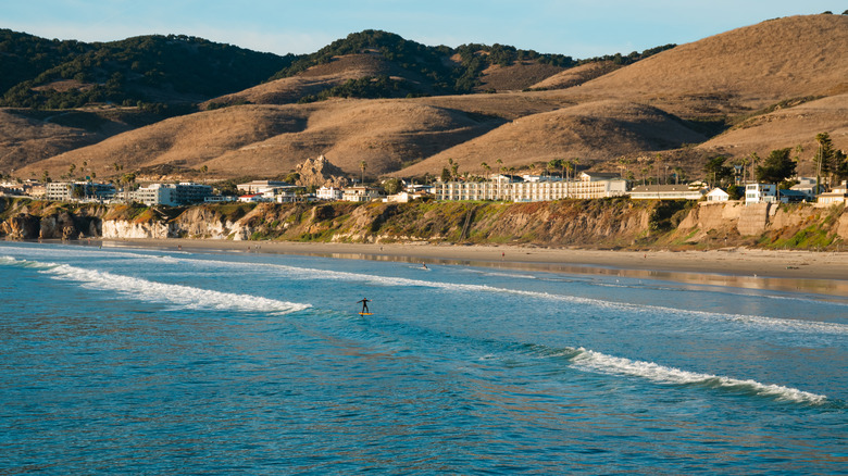 Surfer catching waves on Pismo Beach, California