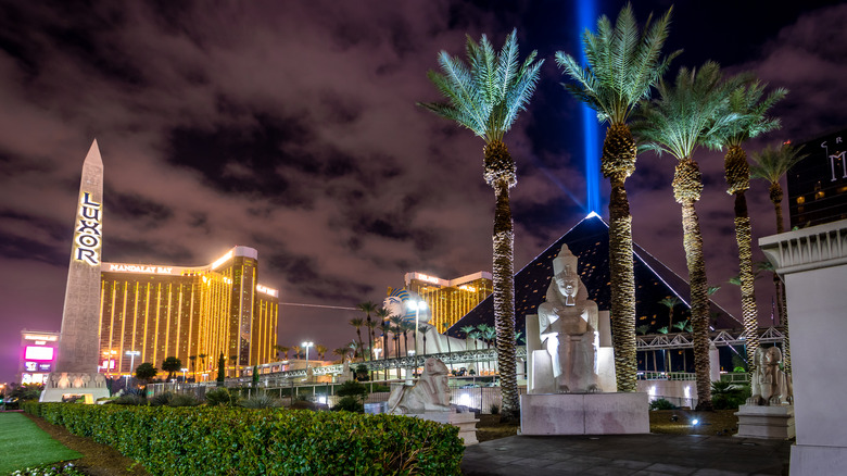 The luxor hotel in Las Vegas at night with light shining from pyramid