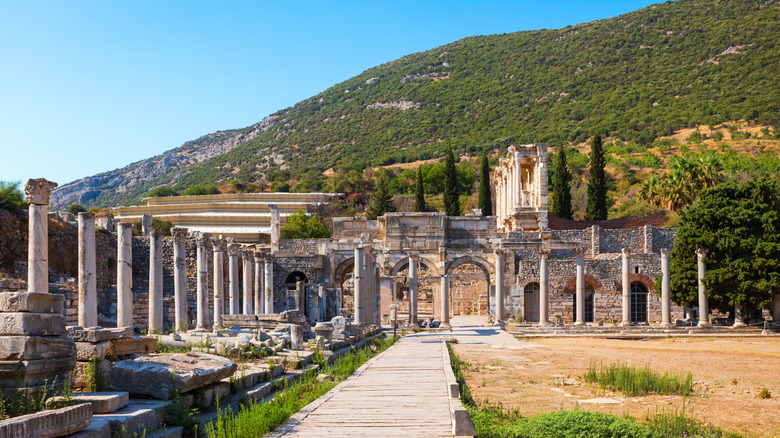 Ancient ruins and colonnades in Ephesus, Turkey with hills in background