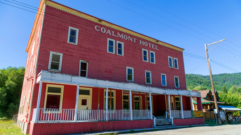 The old Coalmont Hotel is painted red in the middle of Coalmont