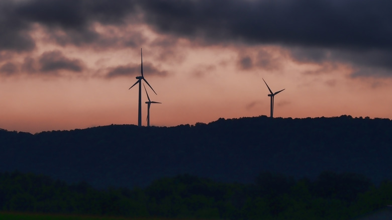 Silhouetted wind farm in New York against the sunrise