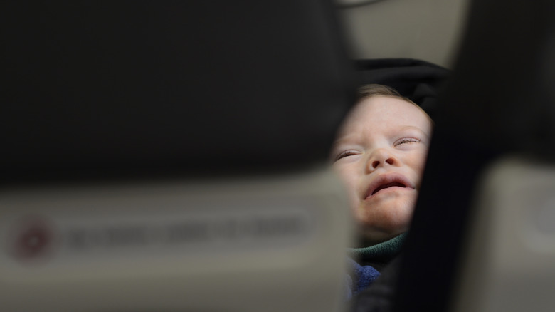 baby crying between airplane seats