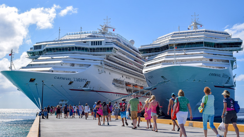 Passengers returning to their cruise ship at a port