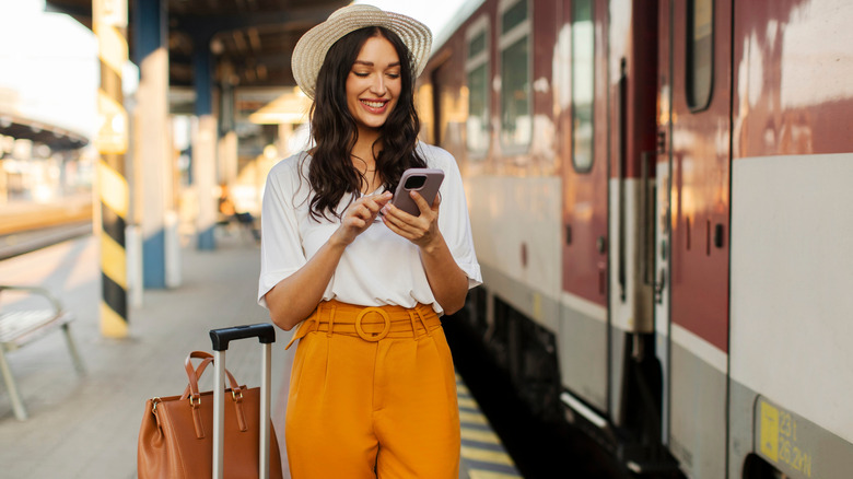 Person standing in front of a train