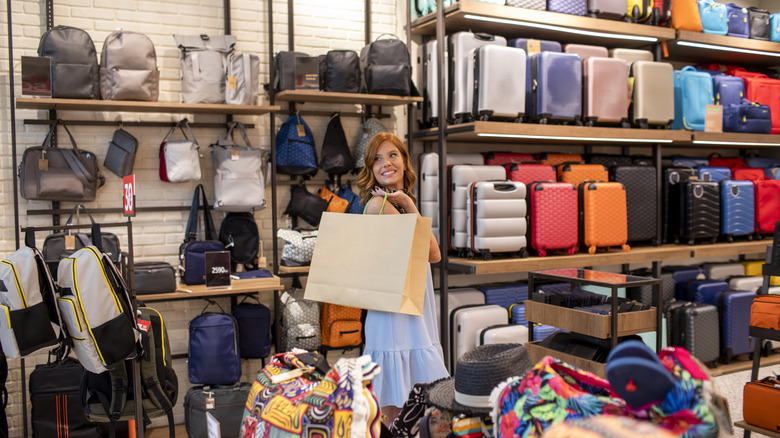 Woman shopping in a luggage store