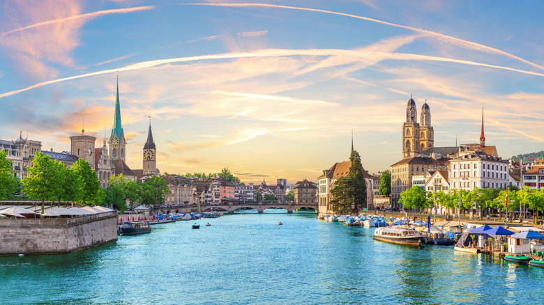 Downtown Zurich at sunset with famous churches and river bridges