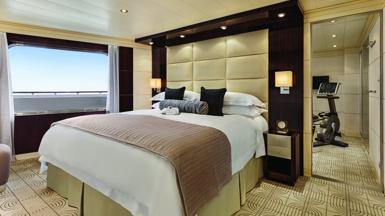 Interior view of the bedroom of the Vista Suite, one of the suites aboard the Oceania Vista.