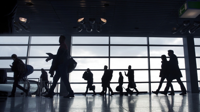 Passengers walking through an airport