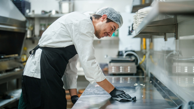 A man cleaning a kitchen