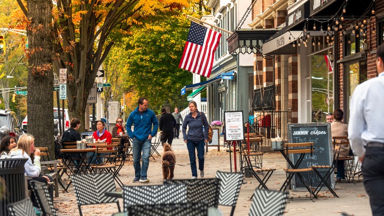 A busy downtown street with tables and people
