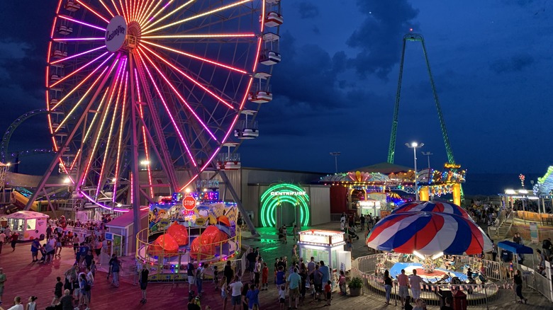 Large ferris wheel lit in colorful lights on Seaside Heights' boardwalk