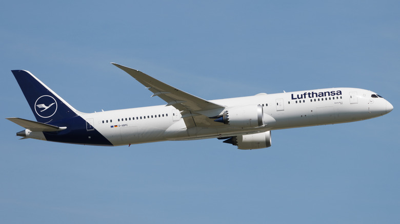 Lufthansa's Boeing 787-9 Dreamliner flying through a blue sky