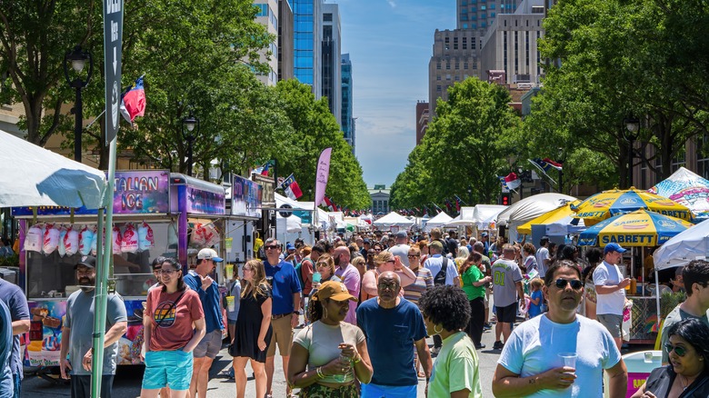 Crowds of pedestrians fill Fayetteville Street in Raleigh, North Carolina