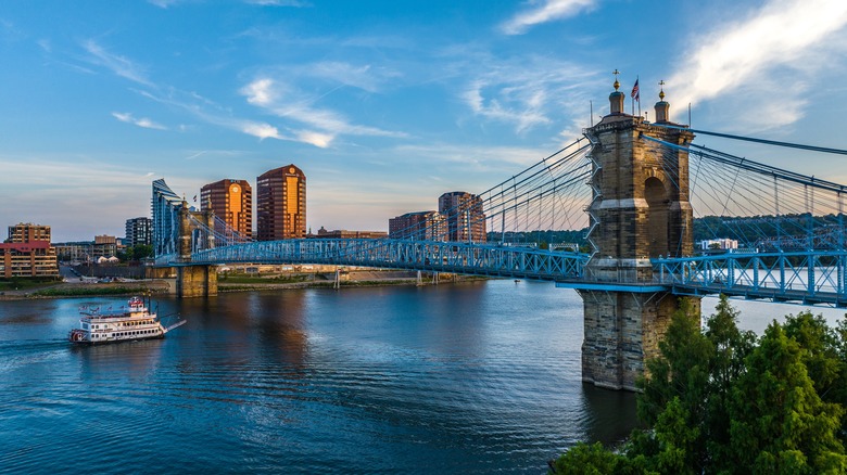 View of the John A. Roebling Suspension Bridge as a boat sails under