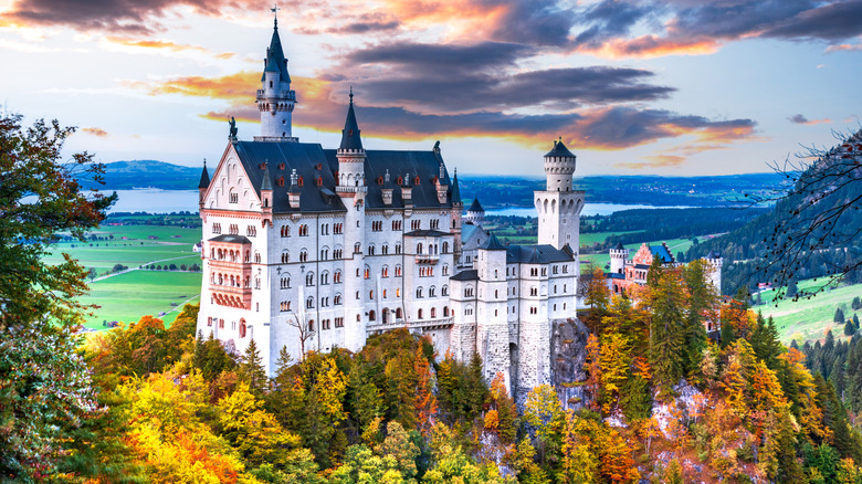 Neuschwanstein Castle surrounded by autumn foliage