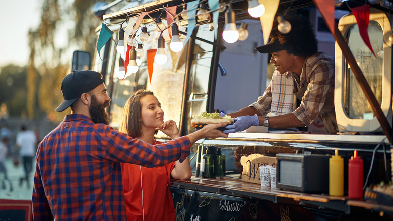 Couple getting food from food truck
