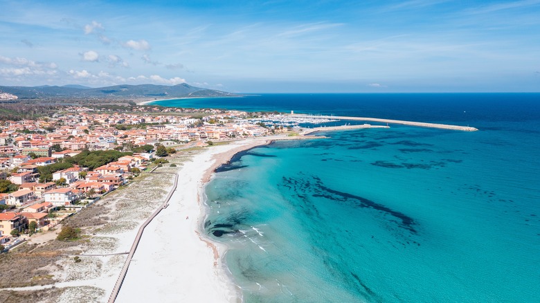 Aerial view of La Caletta Beach with the harbor town in background