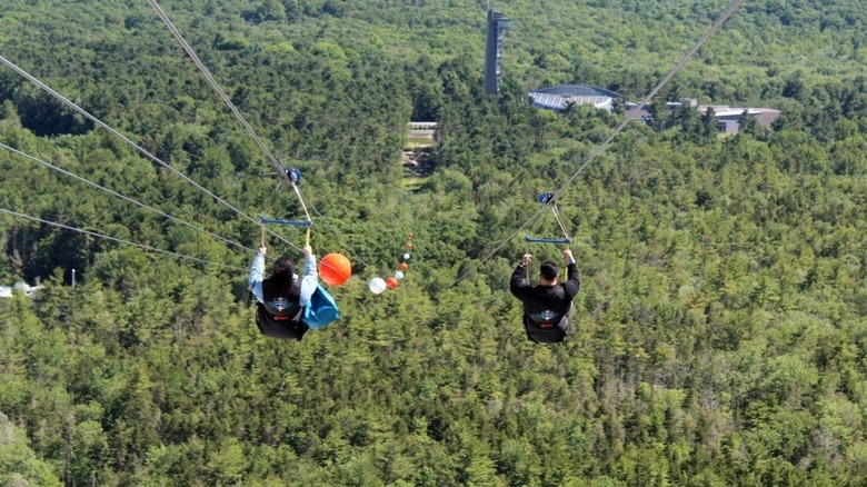 Two people on the HighFlyer zipline at Foxwoods